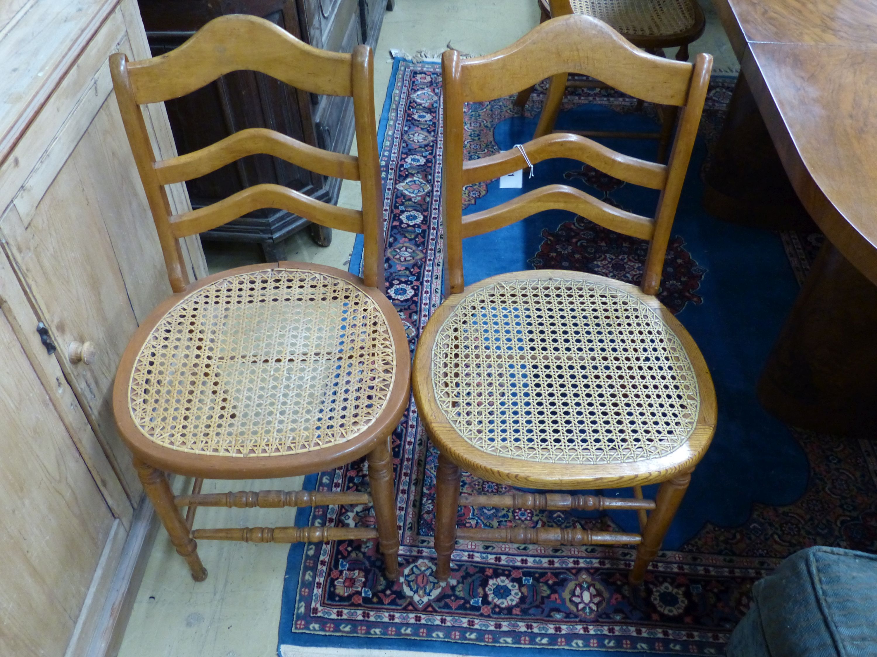 A set of six late Victorian beech kitchen chairs with caned seats